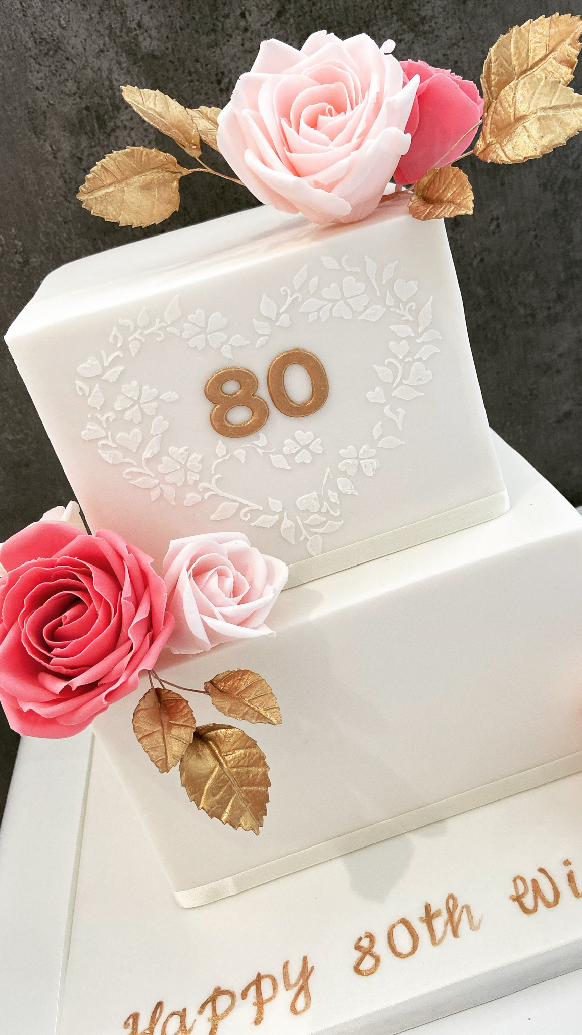 Two-tier square birthday or wedding cake with sugar flowers