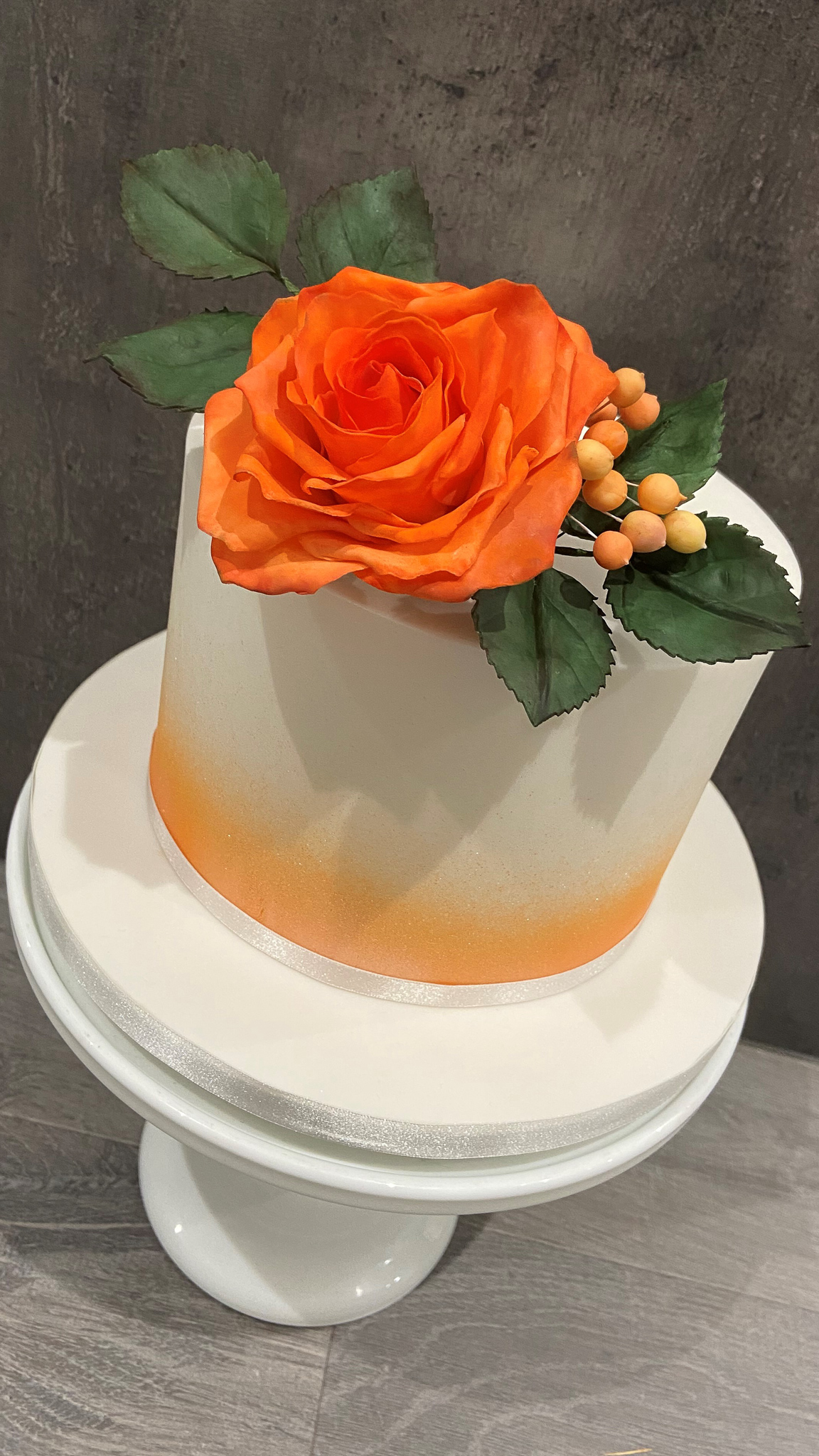 Burnt orange Ombre effect luxury cake with sugar rose and berries