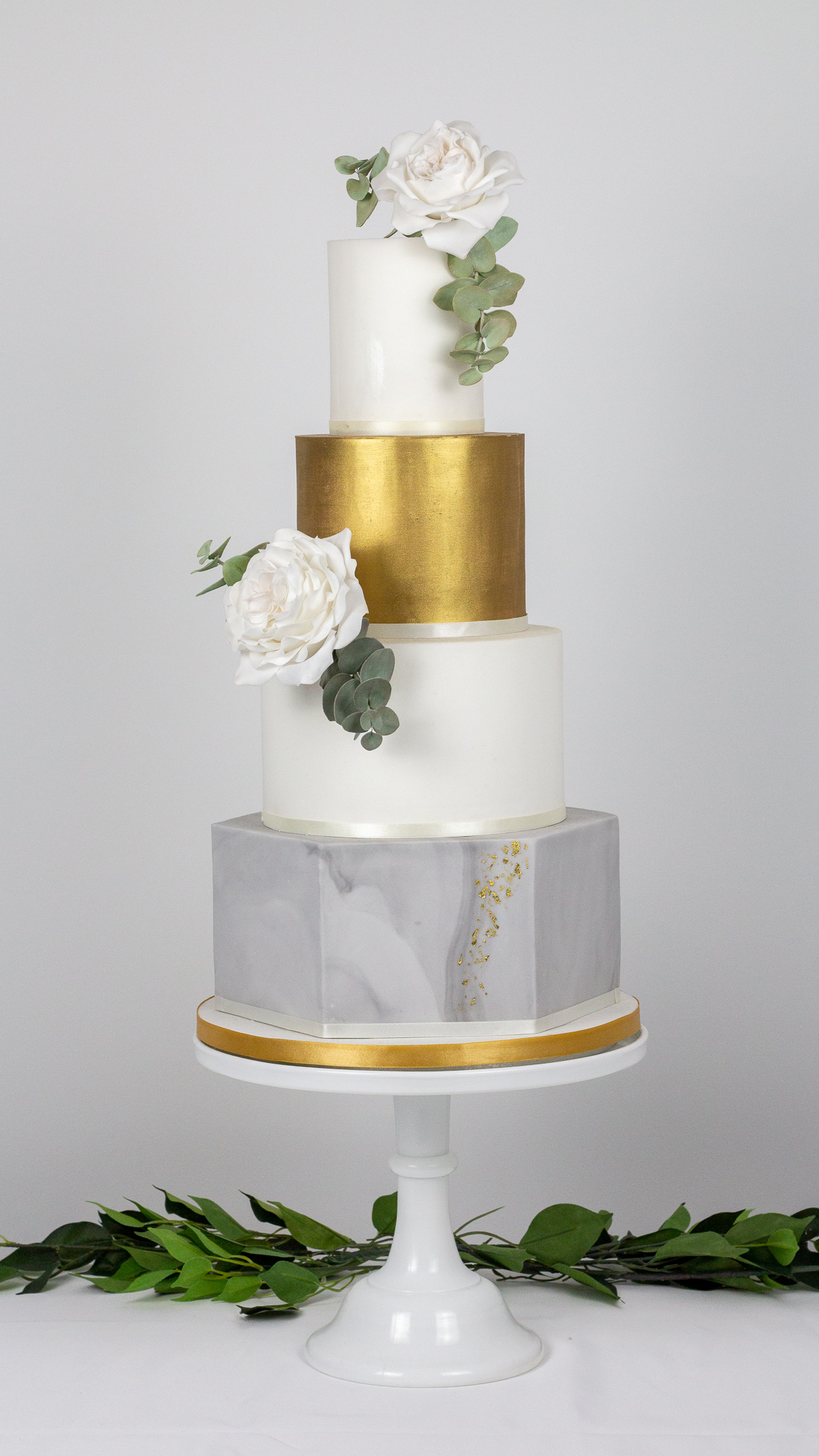 Elegant Wedding cake with marbled hexagon tier gold lustered tier and sugar flowers