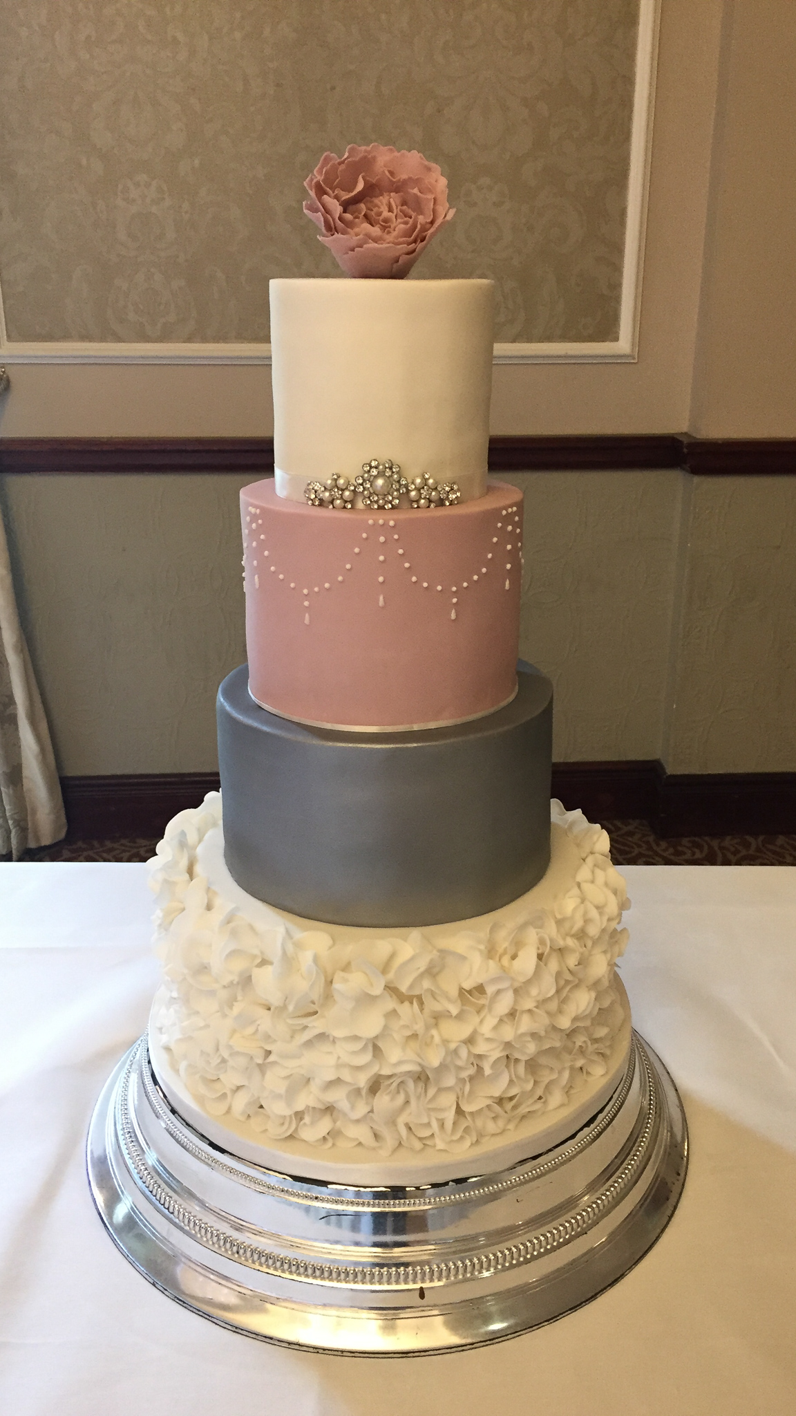 Four-tier luxury wedding cake with sugar ruffles
