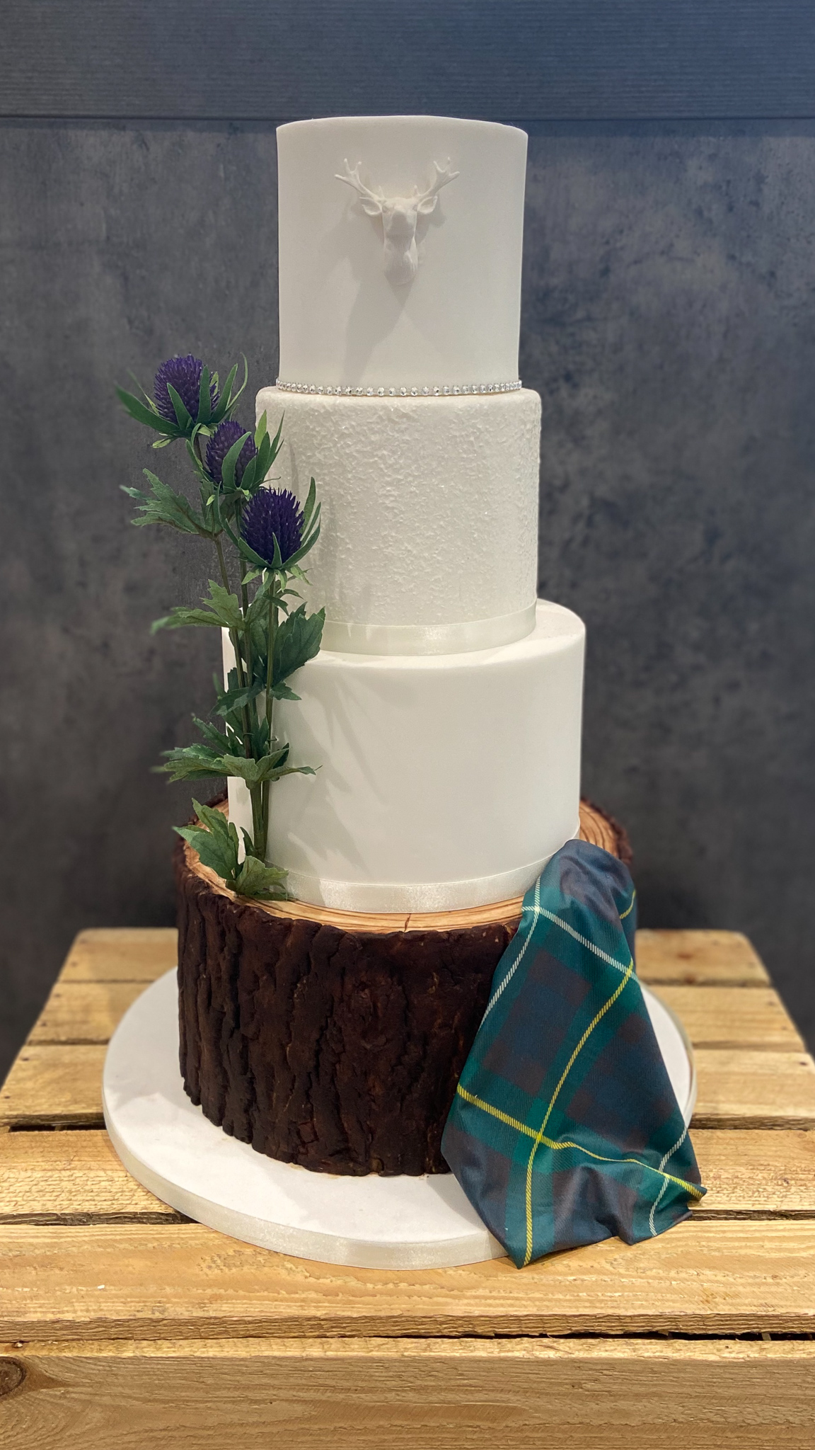 Scottish themed wedding cake with log effect base tier and edible tartan
