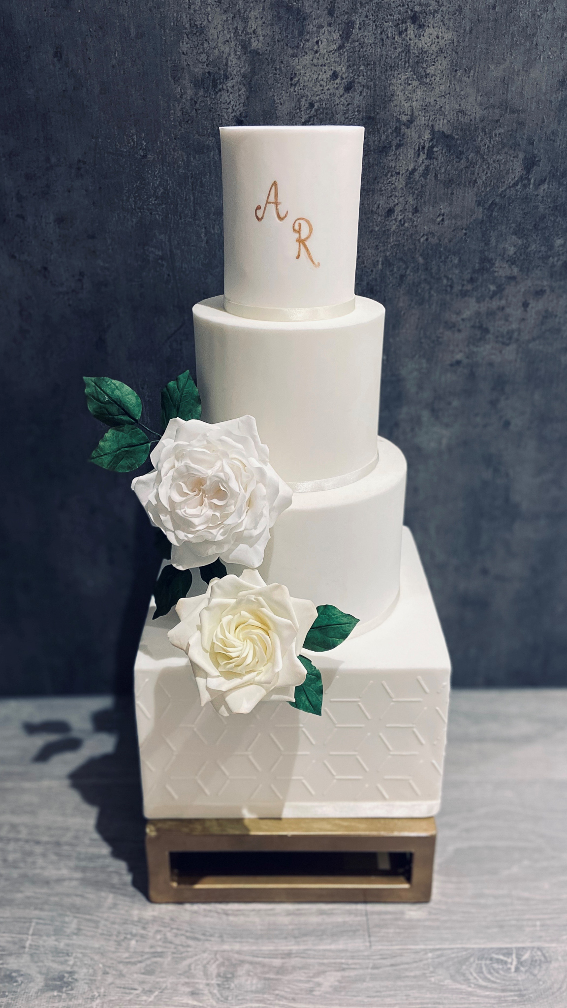 Four tier wedding cake with square base and statement sugar flowers