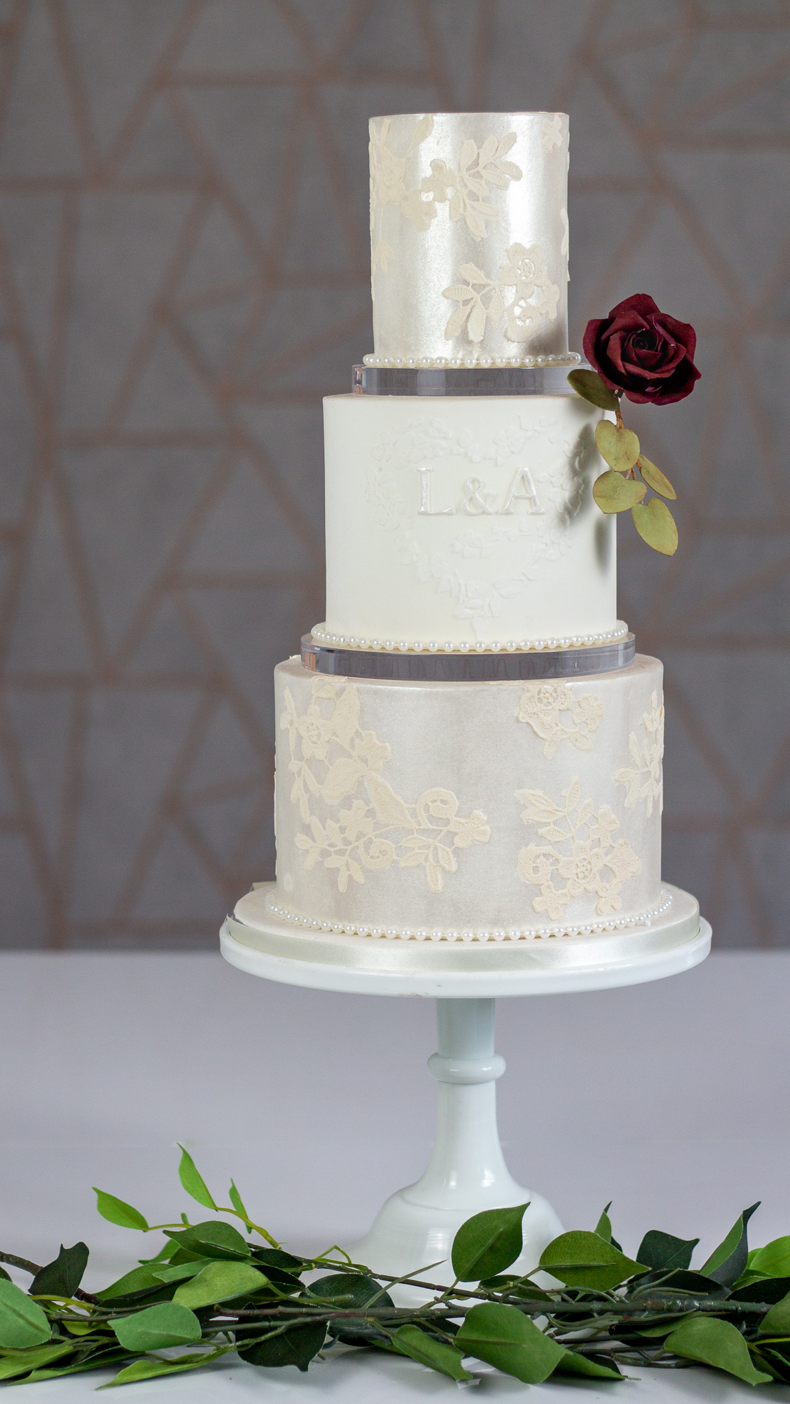 Three tier lustre and lace wedding cake with clear separators